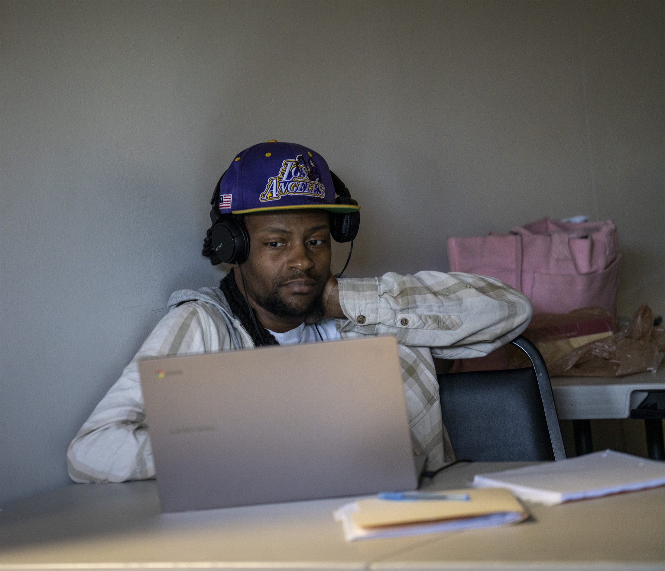 An orientation participant working through training material on a laptop.